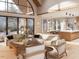Bright and open living room with large windows, hardwood floors, and a view into the kitchen at 8016 Penny Rd, Raleigh, NC 27606