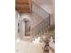 Elegant staircase with wood and iron railings, complemented by light hardwood floors and stylish decor at 8016 Penny Rd, Raleigh, NC 27606