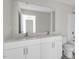 Modern bathroom with double vanity, white cabinets, and a large mirror at 813 Old Tarboro Rd, Wendell, NC 27591