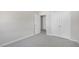 View of a bedroom with neutral paint, carpet flooring, a large closet and white doors at 813 Old Tarboro Rd, Wendell, NC 27591