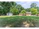 Spacious backyard featuring a storage shed and back of the house and deck at 908 Clarion Dr, Durham, NC 27705
