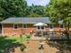 Spacious wooden deck with seating area, overlooking a lush green backyard at 908 Clarion Dr, Durham, NC 27705