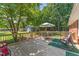 Large backyard deck featuring seating and a view of the tree-lined yard at 908 Clarion Dr, Durham, NC 27705