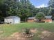 Spacious backyard with a storage shed, a deck, and a well-maintained lawn perfect for outdoor activities at 908 Clarion Dr, Durham, NC 27705