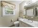 Bathroom featuring a sink vanity, toilet, and window with natural light at 908 Clarion Dr, Durham, NC 27705