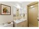 Cozy bathroom featuring a tile shower, built-in vanity, and decorative wall art at 908 Clarion Dr, Durham, NC 27705