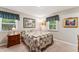 Spacious bedroom featuring two windows, a patterned quilt, and ample natural light at 908 Clarion Dr, Durham, NC 27705