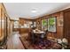 The dining room has wood paneling, view of kitchen, and a large window at 908 Clarion Dr, Durham, NC 27705