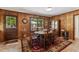 Open dining room features wood paneling, view of the backyard, and a cabinet at 908 Clarion Dr, Durham, NC 27705