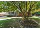 Charming single-story brick home featuring a welcoming front porch and mature trees at 908 Clarion Dr, Durham, NC 27705