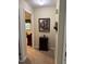 Neutral hallway with an accent cabinet, painting, and view into the bedroom at 908 Clarion Dr, Durham, NC 27705