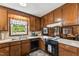 Features a stainless steel sink, black dishwasher, and a view of the outside at 908 Clarion Dr, Durham, NC 27705