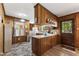 Cozy kitchen features wood paneling, white countertops, and modern appliances at 908 Clarion Dr, Durham, NC 27705