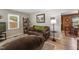 Comfortable living room with hardwood floors, cozy seating, and a view into the dining area, creating a welcoming space at 908 Clarion Dr, Durham, NC 27705
