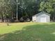 View of the spacious storage shed and adjacent yard, ready to hold vehicles and equipment at 908 Clarion Dr, Durham, NC 27705