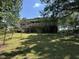 Exterior of home with upper deck, stairs, and a green backyard at 101 Creekside Dr, Selma, NC 27576