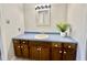 Bathroom with wood vanity, blue countertop, and a modern light fixture at 101 Creekside Dr, Selma, NC 27576