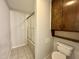 Well-maintained bathroom with a tiled shower/tub combination and practical storage solutions at 101 Creekside Dr, Selma, NC 27576