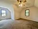 Large bedroom featuring neutral carpet, fan, and two windows at 101 Creekside Dr, Selma, NC 27576