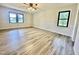 Spacious bedroom featuring wood-look floors and large windows offering natural light at 101 Creekside Dr, Selma, NC 27576