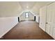 Lofted bonus room with neutral carpet and window at 101 Creekside Dr, Selma, NC 27576