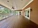 Spacious covered deck features wood flooring, a ceiling fan, and opens to the backyard at 101 Creekside Dr, Selma, NC 27576