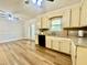 Bright kitchen with wooden floors, painted cabinets, and ample counter space at 101 Creekside Dr, Selma, NC 27576