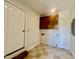 Bright laundry room with checkerboard tile, cabinets, and white door at 101 Creekside Dr, Selma, NC 27576