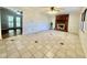 Bright living room featuring tile floors, a brick fireplace, and doors leading to an outdoor space at 101 Creekside Dr, Selma, NC 27576