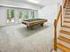Spacious basement with a pool table, staircase, and large windows at 101 Painted Rock Ct, Garner, NC 27529