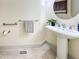 Bathroom features a pedestal sink, and a modern round mirror and stainless steel fixtures at 101 Painted Rock Ct, Garner, NC 27529