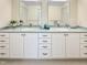 Bathroom with double sinks, white cabinets, grey countertops, and large mirrors at 101 Painted Rock Ct, Garner, NC 27529