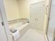 Bright bathroom features a soaking tub with tile surround and updated fixtures at 101 Painted Rock Ct, Garner, NC 27529