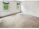 Bedroom with neutral walls, carpeted floors, and windows allowing natural light at 101 Painted Rock Ct, Garner, NC 27529