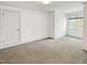 Neutral bedroom featuring carpet and large window with ample natural light at 101 Painted Rock Ct, Garner, NC 27529