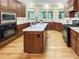 Gourmet kitchen boasts custom cabinets, quartz countertops, stainless steel appliances, and a kitchen island at 101 Painted Rock Ct, Garner, NC 27529