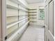 Large pantry with ample shelving and natural light coming through a window at 101 Painted Rock Ct, Garner, NC 27529