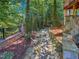 Backyard walkway with landscape blocks leads through a wooded garden at 101 Painted Rock Ct, Garner, NC 27529