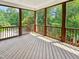 Relaxing screened porch with wood flooring overlooking a lush, green yard at 101 Painted Rock Ct, Garner, NC 27529