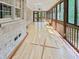 Large sunroom features hardwood flooring, brick accents, and natural light at 101 Painted Rock Ct, Garner, NC 27529