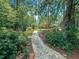 A pathway through a lush backyard leads to a well-manicured lawn at 101 Painted Rock Ct, Garner, NC 27529