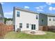 A spacious fenced backyard featuring a fire pit and manicured lawn, perfect for outdoor entertaining and relaxation at 1022 Homecoming Way, Durham, NC 27703