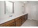 Bathroom featuring double sinks, modern mirrors, wood cabinets, and tile flooring at 1022 Homecoming Way, Durham, NC 27703