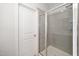 Bathroom featuring a glass enclosed shower with neutral tile and a white door leading out of the bathroom at 1022 Homecoming Way, Durham, NC 27703