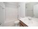 A bathroom shows a vanity with a speckled quartz countertop, toilet and a bathtub/shower combo with white tiling at 1022 Homecoming Way, Durham, NC 27703