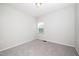 A simple bedroom with neutral walls and carpet features a single window and an air vent at 1022 Homecoming Way, Durham, NC 27703