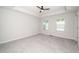A spacious bedroom features neutral walls, carpet and ceiling fan and a pair of windows that let in natural light at 1022 Homecoming Way, Durham, NC 27703