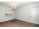 Open dining room with wood-look flooring and modern chandelier fixture at 1022 Homecoming Way, Durham, NC 27703