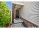 Inviting front entrance with a dark door, brick accents, and neat landscaping at 1022 Homecoming Way, Durham, NC 27703