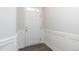 Bright entryway with white door, wainscoting, and wood-look flooring at 1022 Homecoming Way, Durham, NC 27703